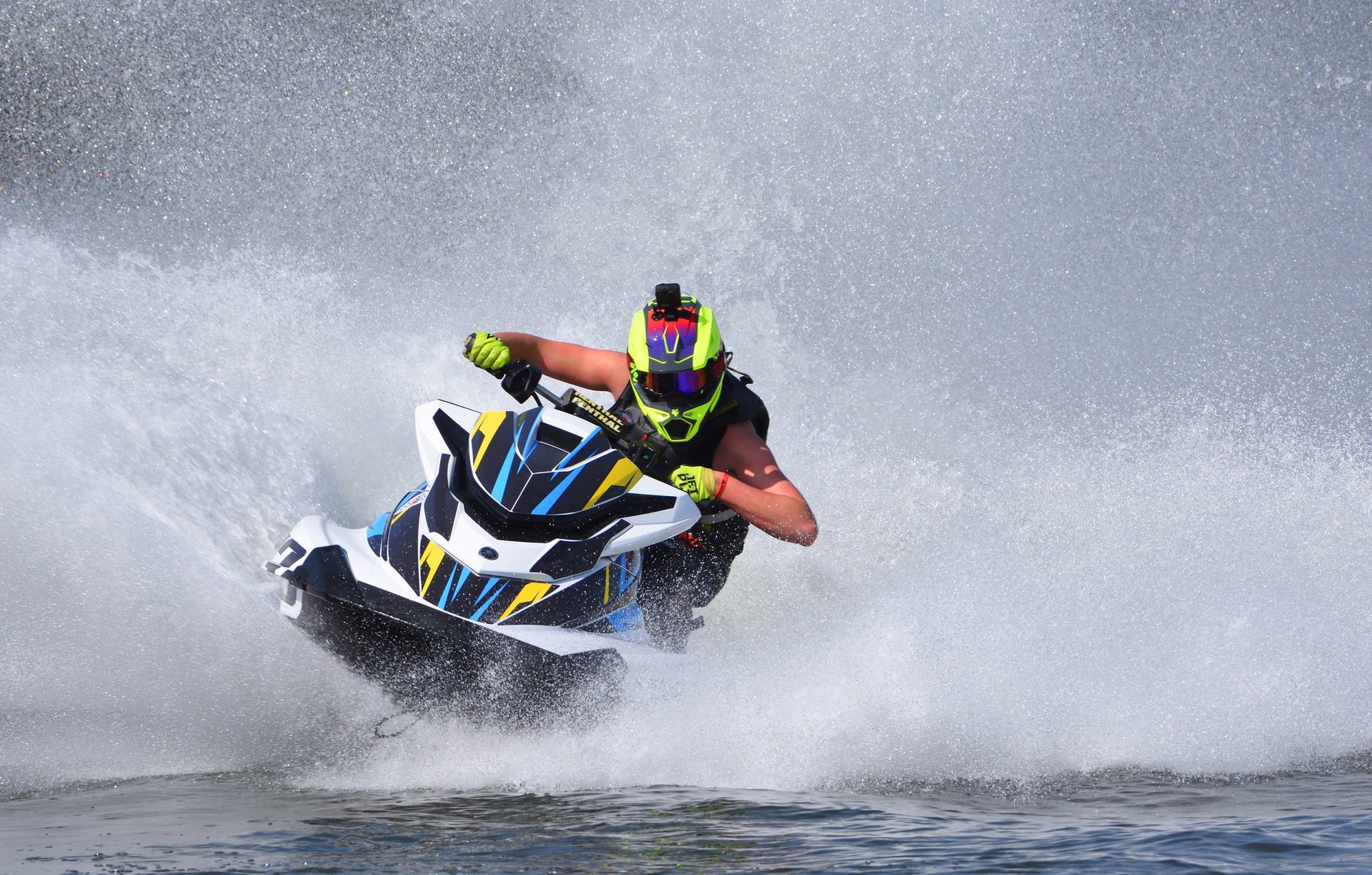 Jet ski racing at high speed creating spray on Miami waters